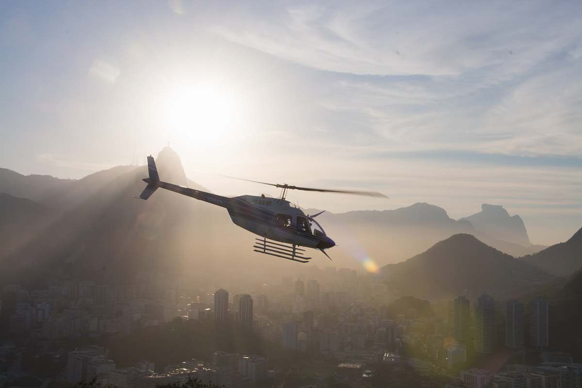 rio de janeiro gray and black helicopter under white cloudy sky during daytime transportation